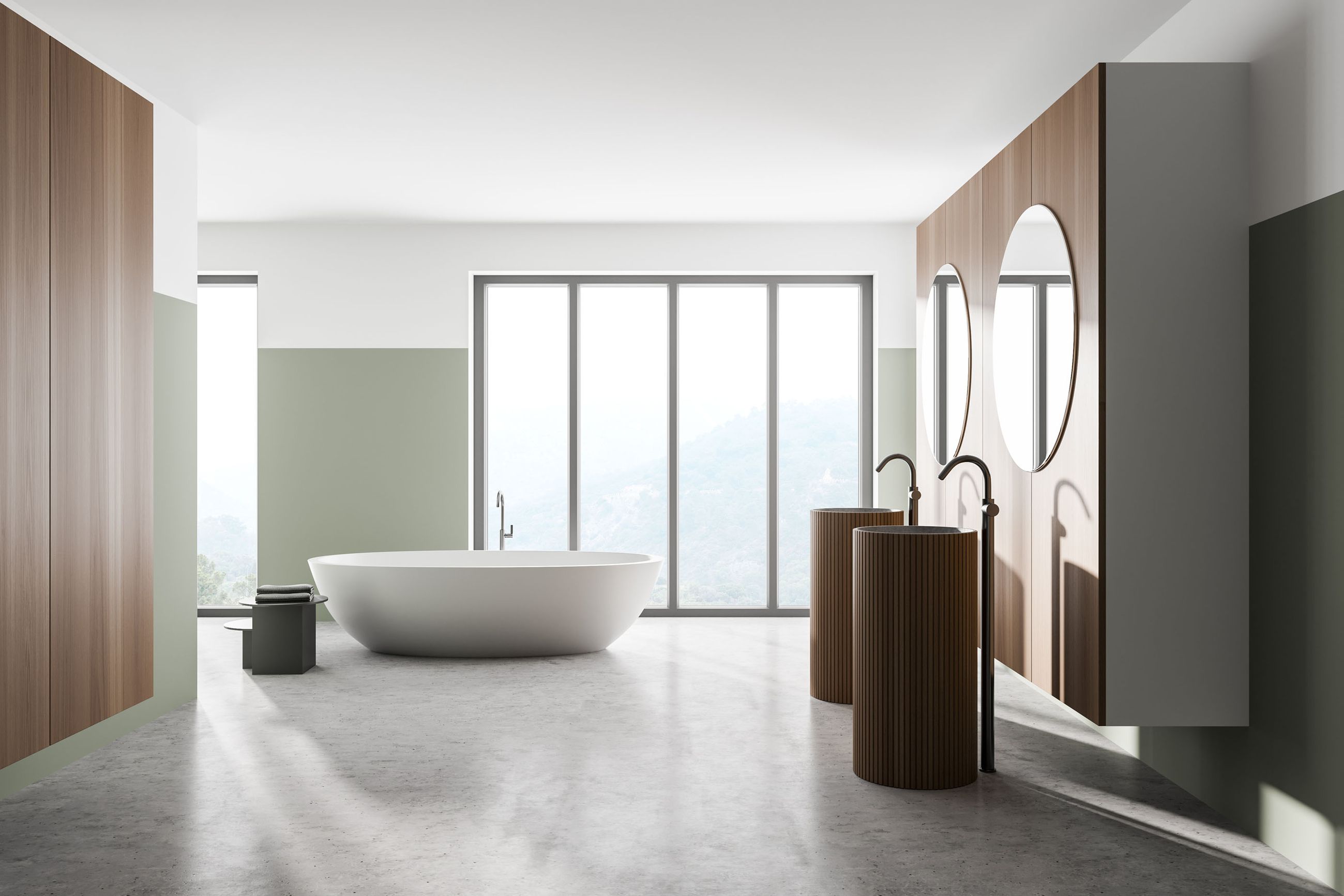 Modernes Badezimmer mit freistehender weißer Badewanne vor großen Fenstern und zwei runden Spiegeln über braunen Waschtischen